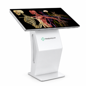 Stehender Touchscreen-Kiosk im medizinischen Bereich, der ein detailliertes menschliches Anatomie-Diagramm (Skelett, Muskeln, Nerven) auf dem Display zeigt, mit dem Logo 'Medyczny.eu' auf dem Ständer.